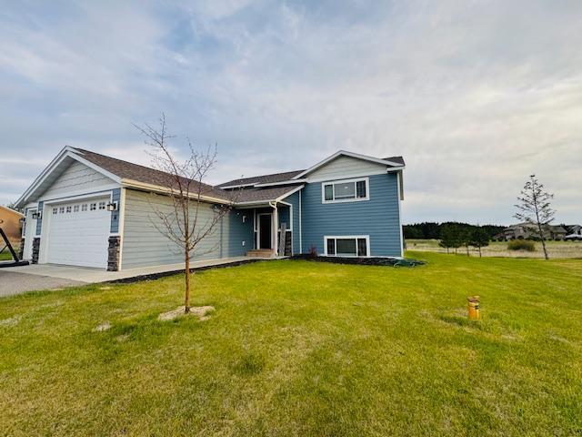 1320 Whiting Rd NW Unit 41, Bemidji, MN 56601 - view of front of house with an attached garage, a front yard, and concrete driveway