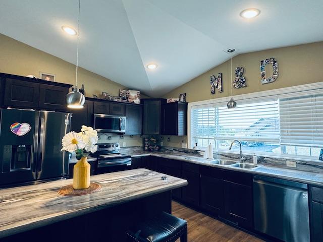 1320 Whiting Rd NW Unit 41, Bemidji, MN 56601 - kitchen featuring stainless steel appliances, a sink, lofted ceiling, pendant lighting, and dark wood finished floors