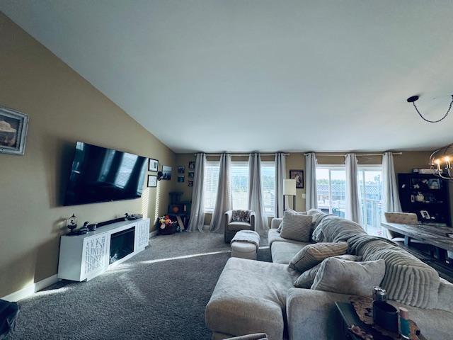1320 Whiting Rd NW Unit 41, Bemidji, MN 56601 - carpeted living area featuring a chandelier and baseboards
