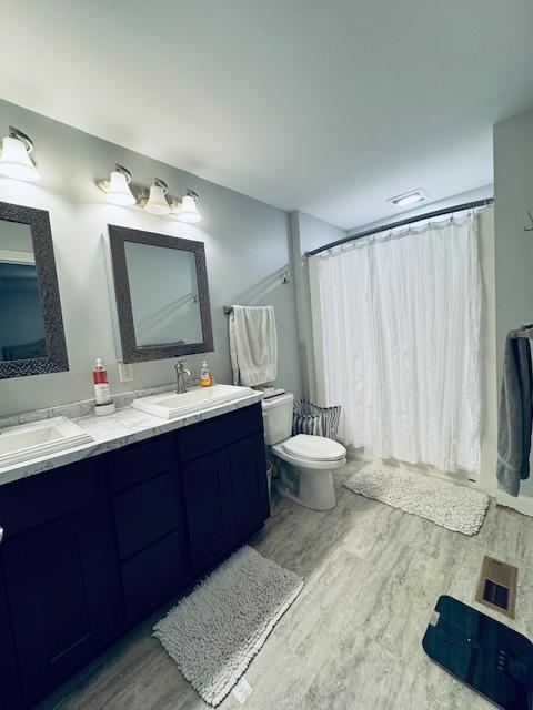 1320 Whiting Rd NW Unit 41, Bemidji, MN 56601 - bathroom with wood finished floors, toilet, and double vanity