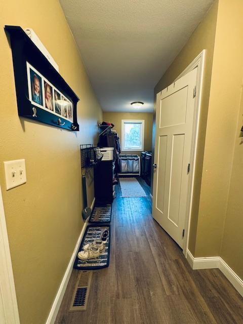 1320 Whiting Rd NW Unit 41, Bemidji, MN 56601 - hall with dark wood-style floors and baseboards