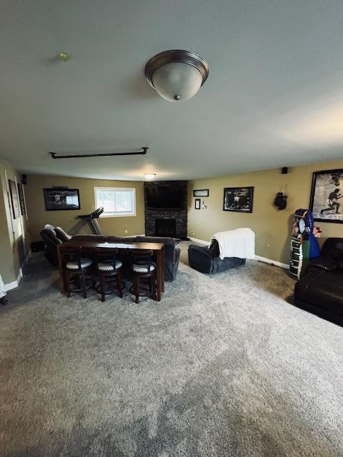 1320 Whiting Rd NW Unit 41, Bemidji, MN 56601 - carpeted living area with a stone fireplace and baseboards