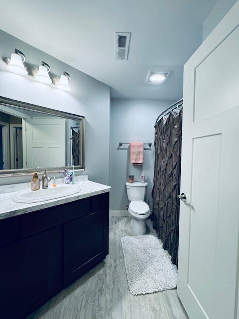 1320 Whiting Rd NW Unit 41, Bemidji, MN 56601 - full bath with toilet, vanity, wood finished floors, and baseboards