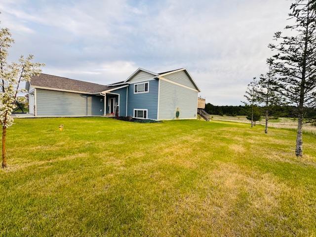 1320 Whiting Rd NW Unit 41, Bemidji, MN 56601 - rear view of house with a yard