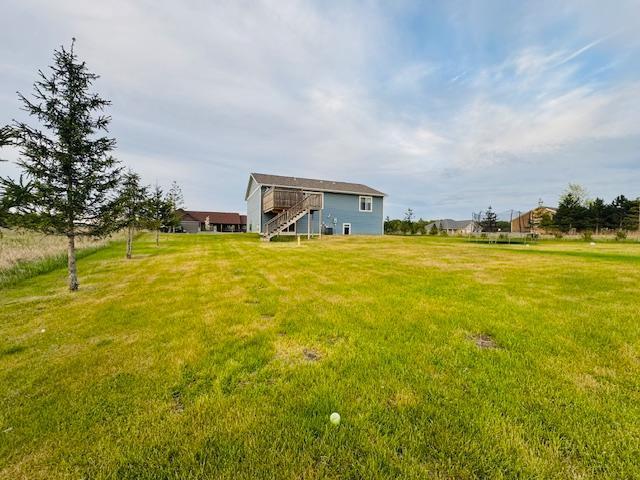 1320 Whiting Rd NW Unit 41, Bemidji, MN 56601 - view of grassy yard with stairway and a wooden deck