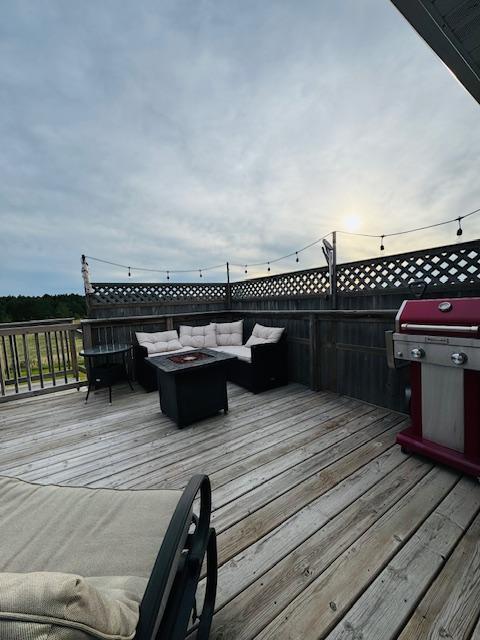 1320 Whiting Rd NW Unit 41, Bemidji, MN 56601 - wooden deck featuring an outdoor living space with a fire pit