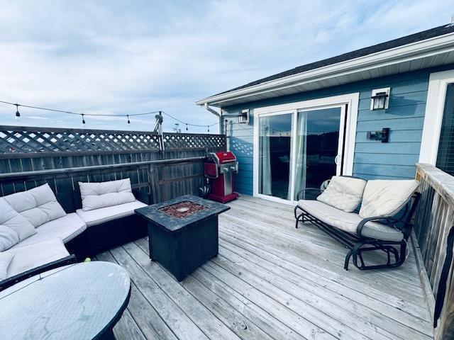 1320 Whiting Rd NW Unit 41, Bemidji, MN 56601 - deck featuring an outdoor living space with a fire pit and a grill