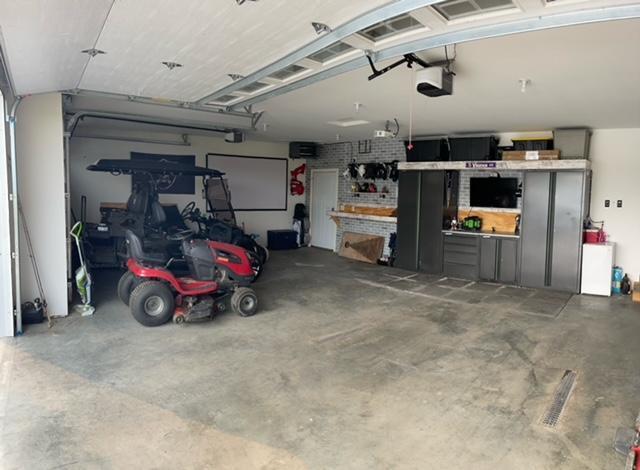 1320 Whiting Rd NW Unit 41, Bemidji, MN 56601 - garage with a garage door opener and a workshop area