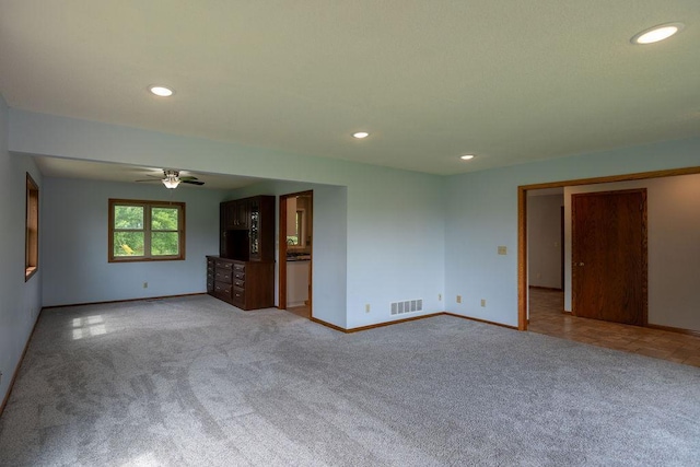 2851 120th Ave SW, Willmar, MN 56201 - unfurnished living room with carpet flooring, baseboards, a ceiling fan, and recessed lighting