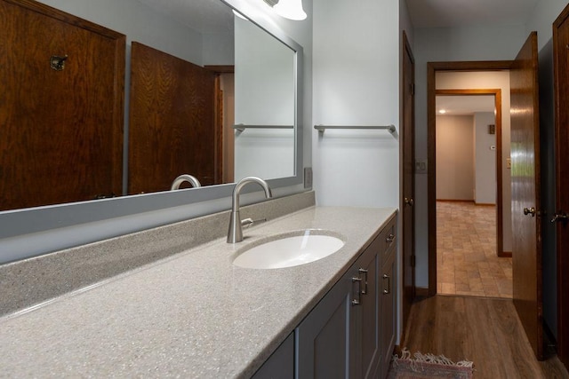 2851 120th Ave SW, Willmar, MN 56201 - bathroom featuring vanity, wood finished floors, and baseboards