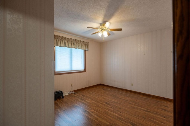 2851 120th Ave SW, Willmar, MN 56201 - unfurnished room with wood finished floors, a textured ceiling, a ceiling fan, and baseboards