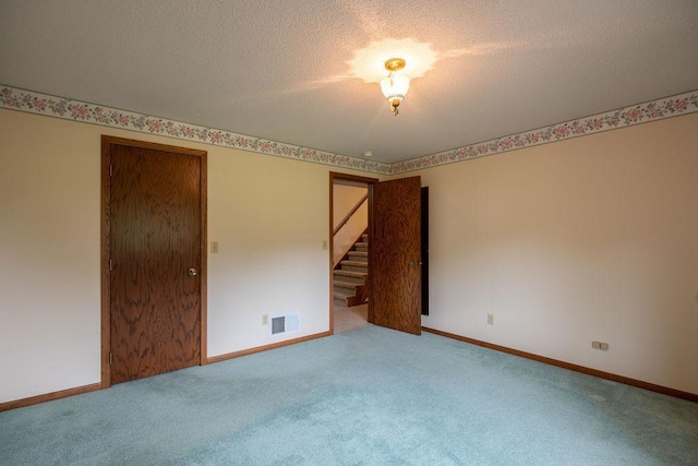2851 120th Ave SW, Willmar, MN 56201 - carpeted empty room featuring stairs, a textured ceiling, and baseboards