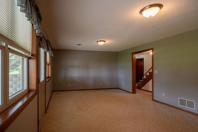 2851 120th Ave SW, Willmar, MN 56201 - unfurnished room featuring light carpet, baseboards, stairs, and a textured ceiling