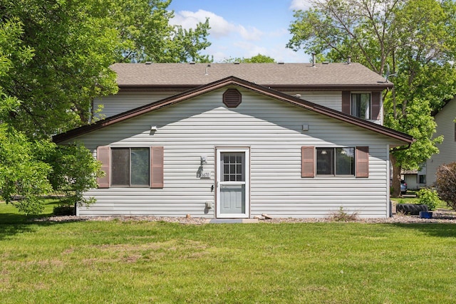 6670 84th Ct N, Brooklyn Park, MN 55445 - rear view of house featuring a yard