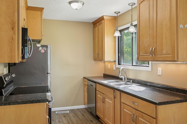 6670 84th Ct N, Brooklyn Park, MN 55445 - kitchen featuring stainless steel appliances, a sink, dark wood finished floors, dark countertops, and a textured ceiling