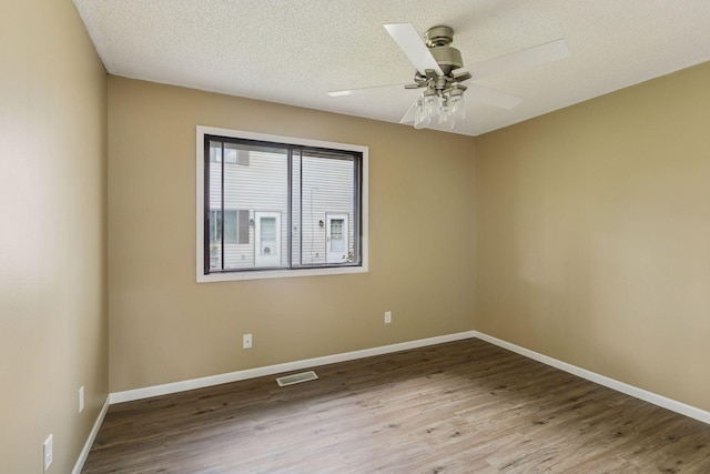 6670 84th Ct N, Brooklyn Park, MN 55445 - empty room with wood finished floors, baseboards, a textured ceiling, and a ceiling fan