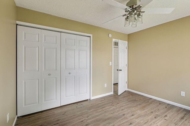 6670 84th Ct N, Brooklyn Park, MN 55445 - unfurnished bedroom with wood finished floors, a closet, and baseboards
