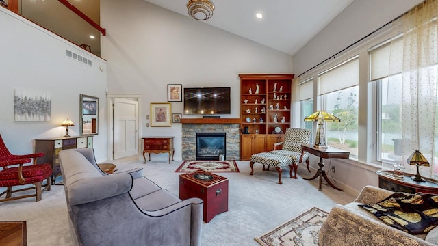 1829 Traders Point Ln SW, Rochester, MN 55902 - carpeted living area with high vaulted ceiling, a stone fireplace, recessed lighting, and baseboards