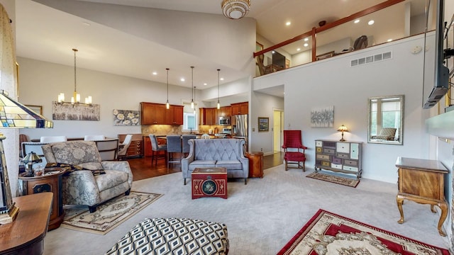 1829 Traders Point Ln SW, Rochester, MN 55902 - living area featuring a chandelier, high vaulted ceiling, light carpet, and recessed lighting