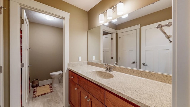 1829 Traders Point Ln SW, Rochester, MN 55902 - bathroom featuring vanity, toilet, and baseboards