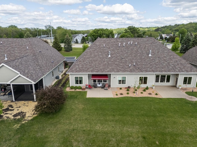 1829 Traders Point Ln SW, Rochester, MN 55902 - back of property with a patio area, a yard, and roof with shingles