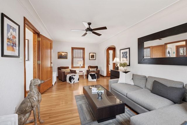 5117 48th St, Edina, MN 55436 - living area with arched walkways, light wood-style flooring, ceiling fan, and crown molding