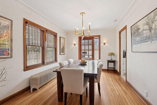 5117 48th St, Edina, MN 55436 - dining area featuring radiator, light wood finished floors, a chandelier, baseboards, and crown molding