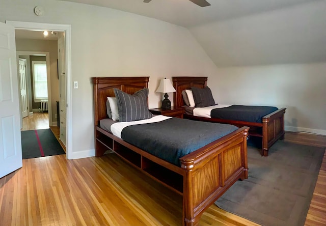 5117 48th St, Edina, MN 55436 - bedroom with light wood-type flooring, radiator heating unit, baseboards, and lofted ceiling