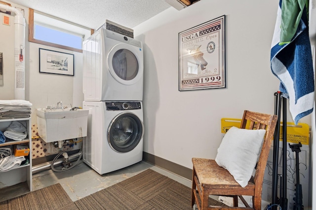 5117 48th St, Edina, MN 55436 - washroom featuring stacked washing machine and dryer, baseboards, a sink, and a textured ceiling