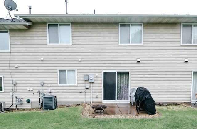 2778 Ridgeview Ln, Red Wing, MN 55066 - back of property featuring a fire pit, central AC unit, a yard, and a patio area