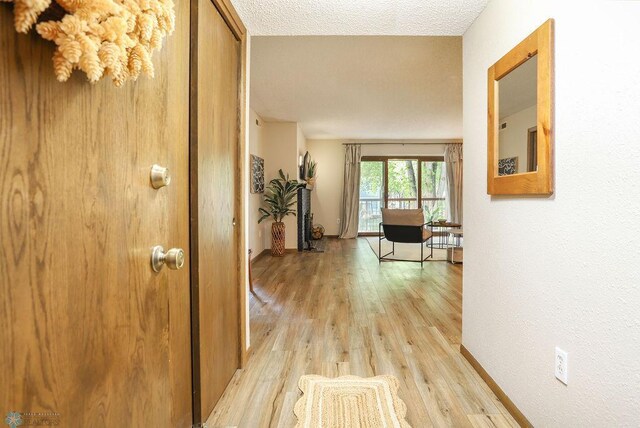 220 8th St S Unit B2, Fargo, ND 58103 - corridor featuring light wood-style floors and a textured ceiling