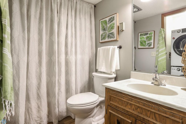 220 8th St S Unit B2, Fargo, ND 58103 - bathroom with estacked washer and dryer, toilet, and vanity