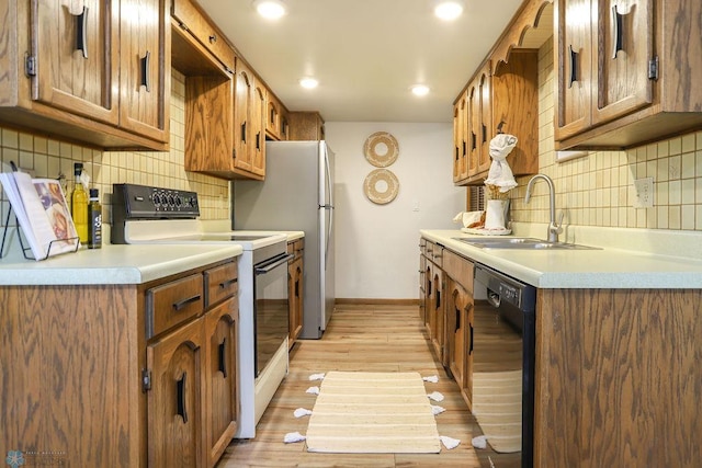 220 8th St S Unit B2, Fargo, ND 58103 - kitchen with dishwasher, white electric stove, a sink, backsplash, and recessed lighting
