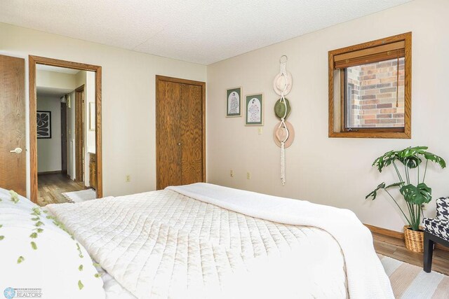220 8th St S Unit B2, Fargo, ND 58103 - bedroom with wood finished floors, a closet, and baseboards