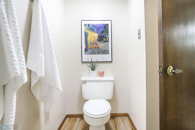 220 8th St S Unit B2, Fargo, ND 58103 - bathroom featuring baseboards, toilet, and wood finished floors