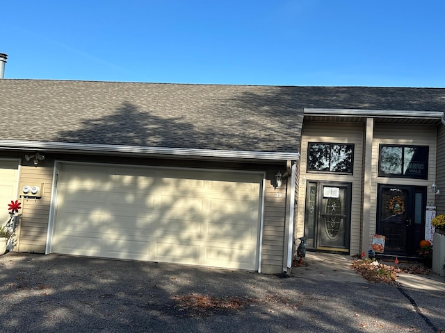 39 Round Lake Trl, Little Canada, MN 55117 - property entrance featuring a garage, asphalt driveway, and a shingled roof