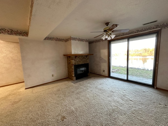 39 Round Lake Trl, Little Canada, MN 55117 - unfurnished living room featuring light colored carpet, ceiling fan, a textured ceiling, a brick fireplace, and baseboards