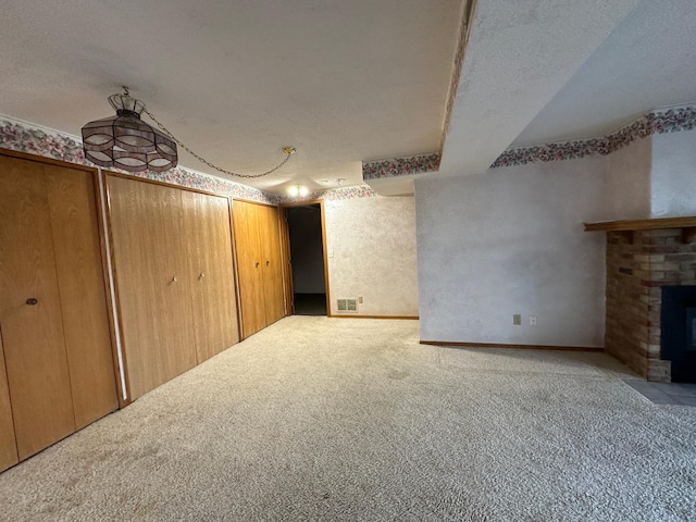 39 Round Lake Trl, Little Canada, MN 55117 - unfurnished living room with carpet flooring, a brick fireplace, and a textured ceiling