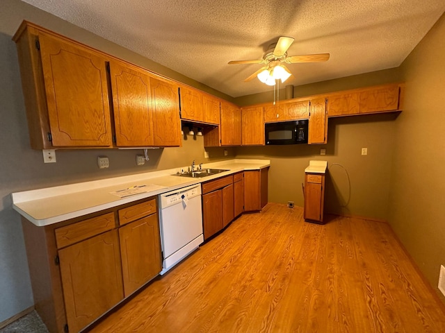 39 Round Lake Trl, Little Canada, MN 55117 - kitchen with white dishwasher, black microwave, a sink, light wood finished floors, and ceiling fan