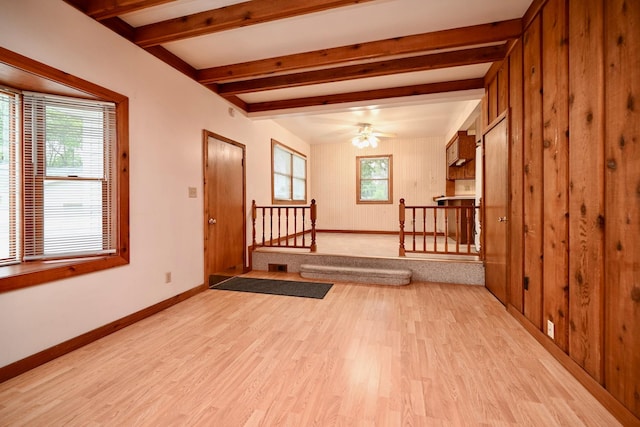919 Howard St, Winona, MN 55987 - unfurnished room with healthy amount of natural light, light wood-style flooring, beamed ceiling, baseboards, and ceiling fan