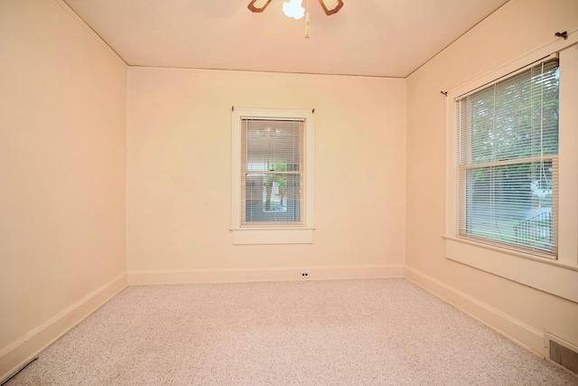 919 Howard St, Winona, MN 55987 - empty room with speckled floor, baseboards, and a ceiling fan