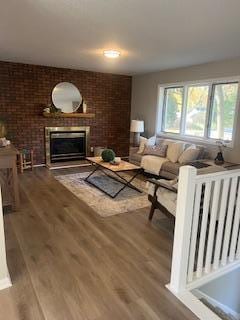 4207 Fillmore St NE, Columbia Heights, MN 55421 - living area with a brick fireplace and wood finished floors