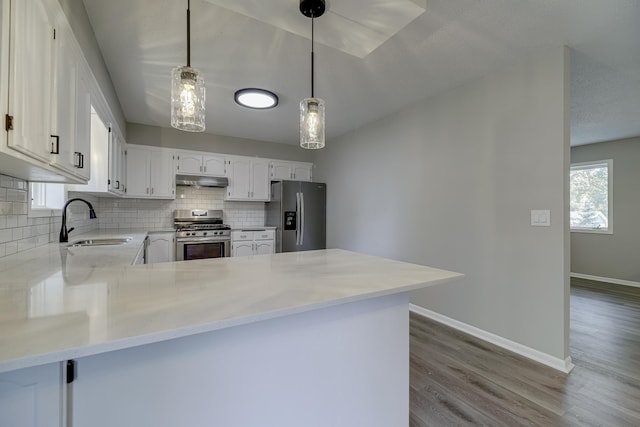 4207 Fillmore St NE, Columbia Heights, MN 55421 - kitchen featuring stainless steel appliances, a sink, backsplash, baseboards, and wood finished floors