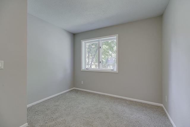 4207 Fillmore St NE, Columbia Heights, MN 55421 - unfurnished room with carpet floors, baseboards, and a textured ceiling