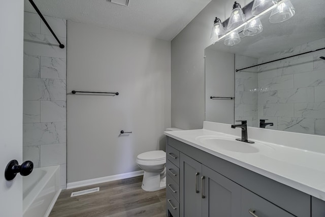 4207 Fillmore St NE, Columbia Heights, MN 55421 - full bathroom featuring vanity, toilet, wood finished floors, baseboards, and tub / shower combination