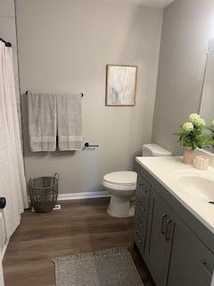 4207 Fillmore St NE, Columbia Heights, MN 55421 - full bathroom featuring vanity, wood finished floors, toilet, and baseboards