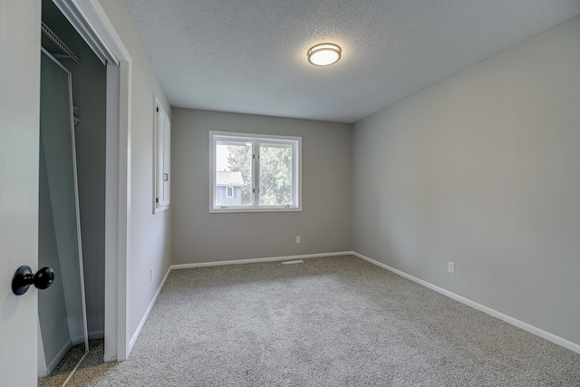 4207 Fillmore St NE, Columbia Heights, MN 55421 - empty room with a textured ceiling, carpet, and baseboards