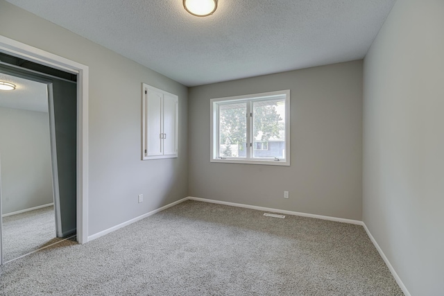 4207 Fillmore St NE, Columbia Heights, MN 55421 - unfurnished bedroom with carpet flooring, a textured ceiling, and baseboards