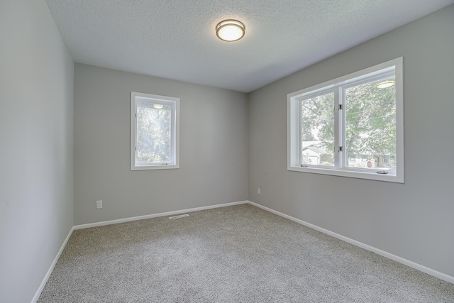 4207 Fillmore St NE, Columbia Heights, MN 55421 - empty room with carpet floors, a textured ceiling, and baseboards