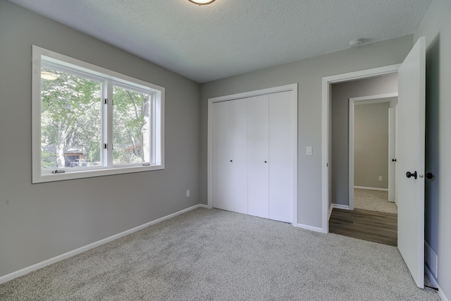 4207 Fillmore St NE, Columbia Heights, MN 55421 - unfurnished bedroom with carpet, a textured ceiling, a closet, and baseboards